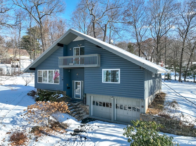 view of front of home featuring a garage and a balcony