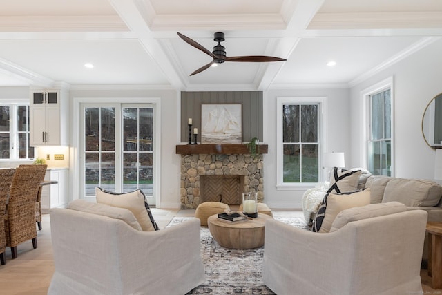 living room featuring ornamental molding, coffered ceiling, beam ceiling, and light wood-type flooring