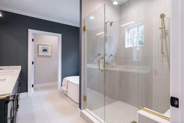 bathroom featuring a shower with door, vanity, and ornamental molding