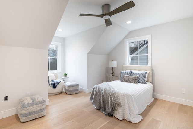 bedroom with vaulted ceiling, ceiling fan, and light wood-type flooring