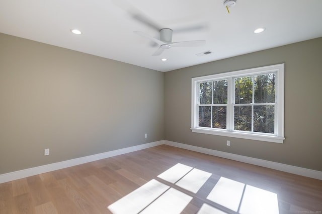 spare room featuring ceiling fan and light hardwood / wood-style flooring