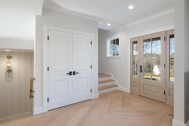 entrance foyer featuring ornamental molding and light parquet floors