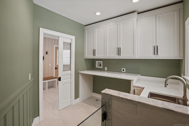 washroom with cabinets, electric dryer hookup, sink, and washer hookup