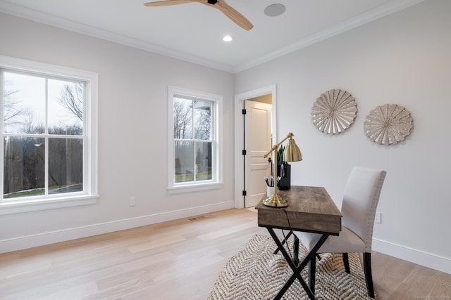 office area featuring plenty of natural light, ornamental molding, ceiling fan, and light wood-type flooring