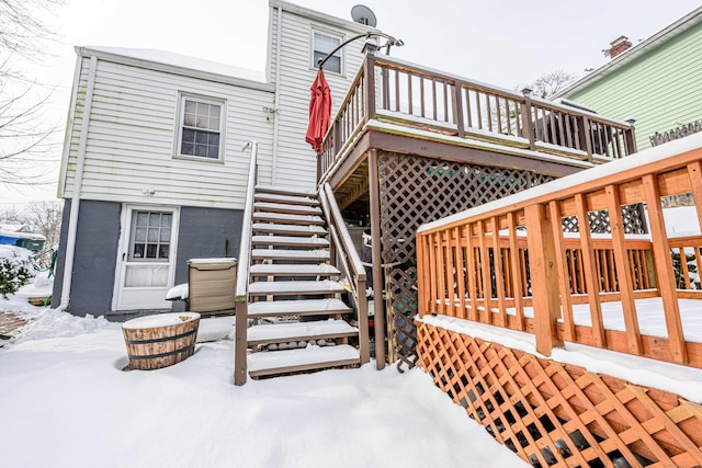 snow covered property featuring a deck