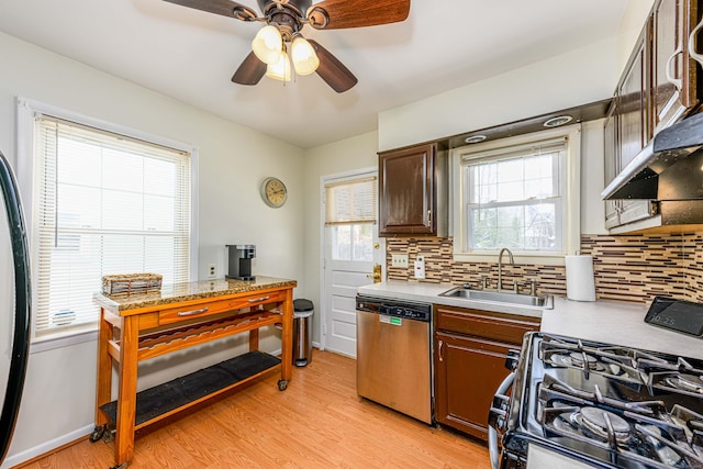 kitchen featuring sink, dishwasher, backsplash, light hardwood / wood-style floors, and range with gas cooktop