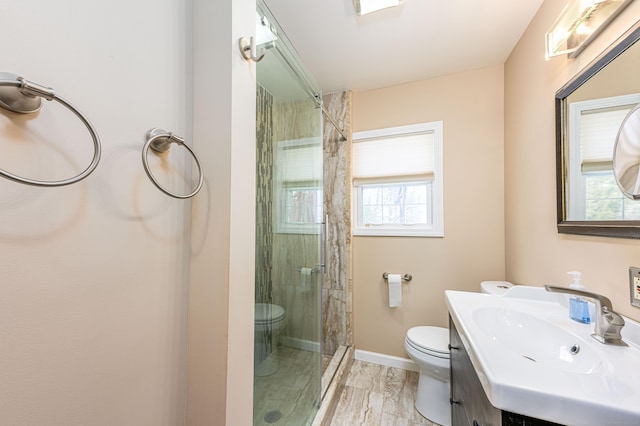 bathroom with vanity, an enclosed shower, plenty of natural light, and toilet