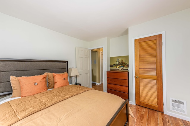 bedroom featuring a closet and light wood-type flooring