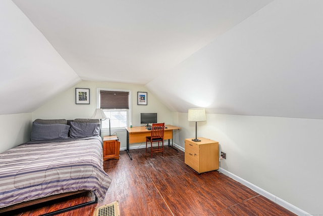 bedroom with dark hardwood / wood-style flooring and vaulted ceiling