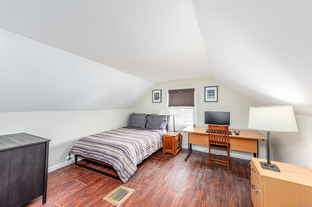 bedroom featuring dark wood-type flooring and vaulted ceiling