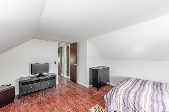 bedroom with lofted ceiling and dark hardwood / wood-style flooring