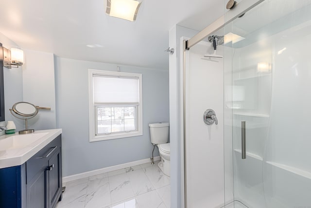 bathroom featuring vanity, toilet, and a shower with door