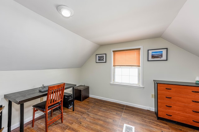 home office with dark hardwood / wood-style flooring and lofted ceiling