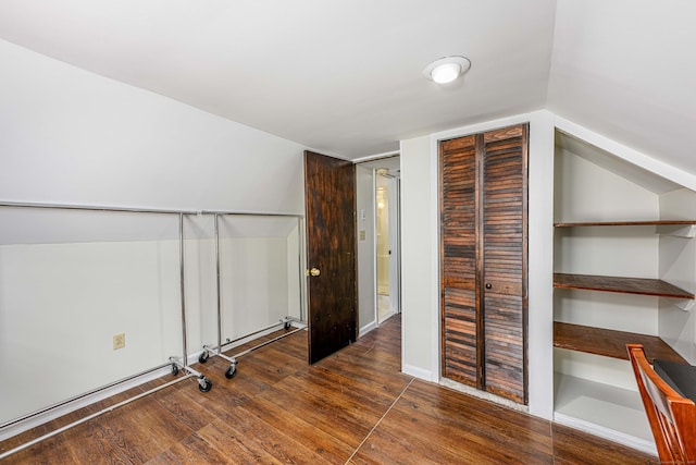 additional living space with lofted ceiling and dark hardwood / wood-style floors