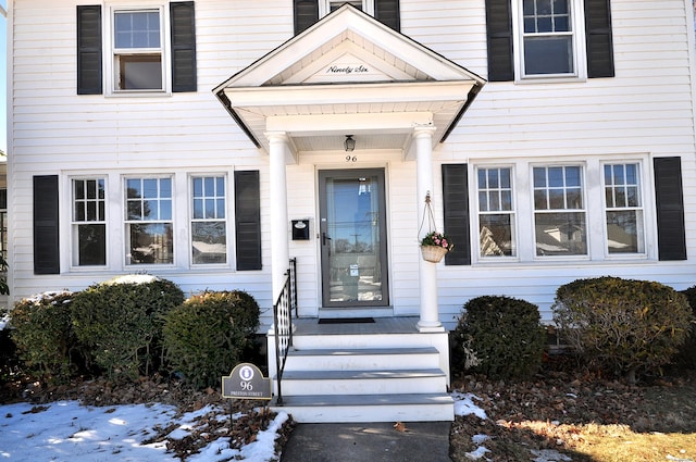 view of snow covered property entrance