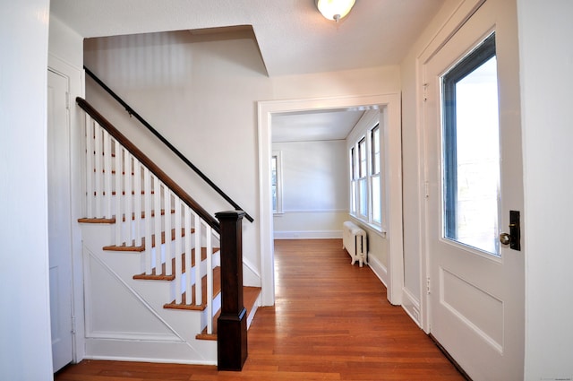 entrance foyer featuring hardwood / wood-style flooring and radiator