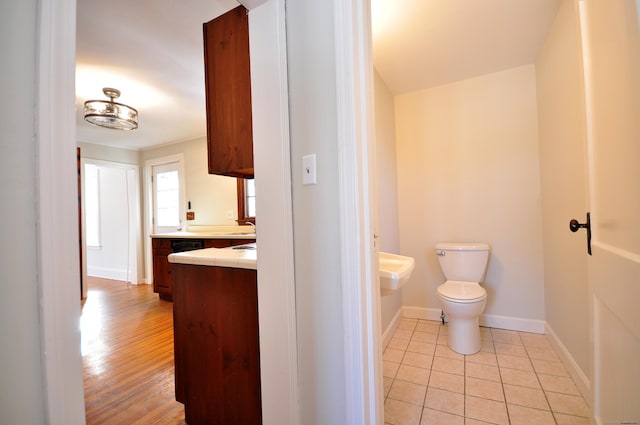 bathroom with sink, toilet, and tile patterned flooring