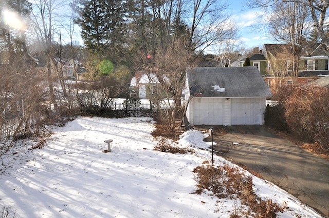 yard covered in snow with a garage