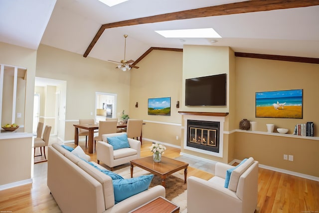 living room with high vaulted ceiling, light hardwood / wood-style floors, and ceiling fan