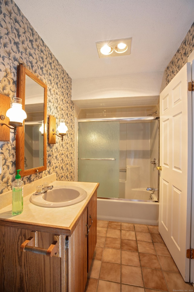 bathroom with enclosed tub / shower combo, a textured ceiling, vanity, and tile patterned floors