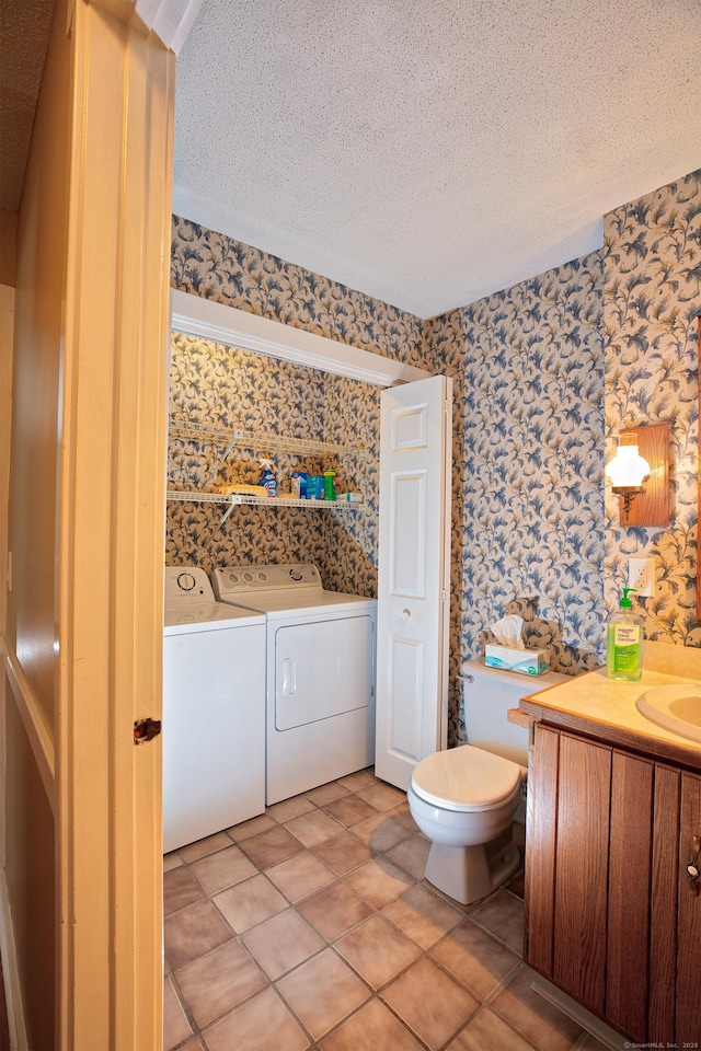 bathroom featuring tile patterned flooring, independent washer and dryer, vanity, a textured ceiling, and toilet