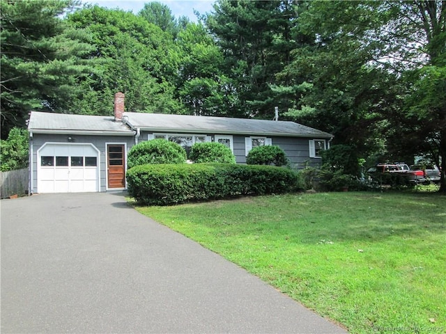 single story home featuring a garage and a front yard