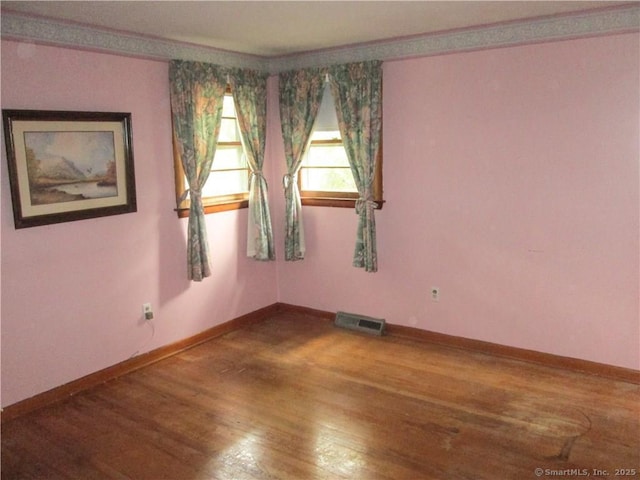 empty room with hardwood / wood-style floors