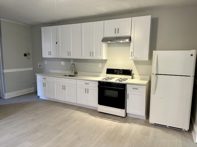 kitchen featuring white cabinetry, gas range oven, and white fridge