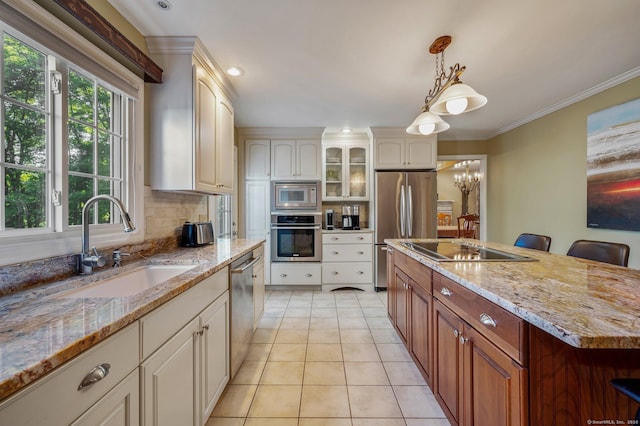 kitchen featuring a kitchen bar, sink, hanging light fixtures, stainless steel appliances, and backsplash