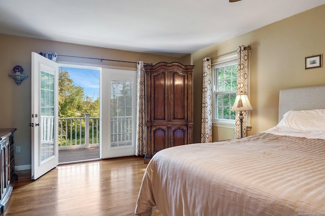 bedroom featuring access to exterior and light hardwood / wood-style flooring