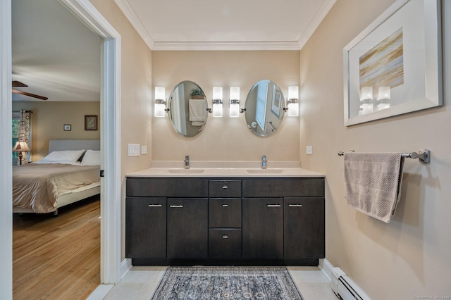 bathroom with vanity, ornamental molding, ceiling fan, and baseboard heating