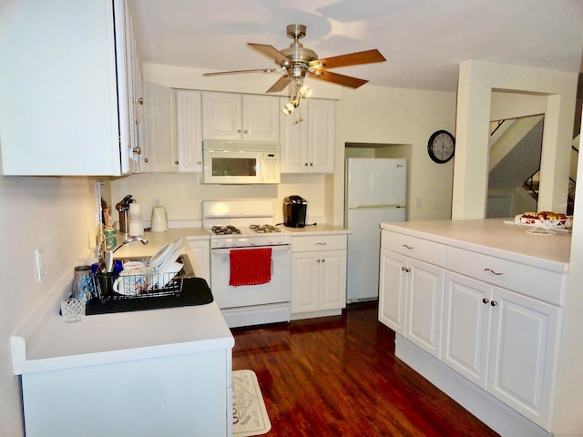 kitchen featuring white cabinetry, sink, dark hardwood / wood-style flooring, ceiling fan, and white appliances