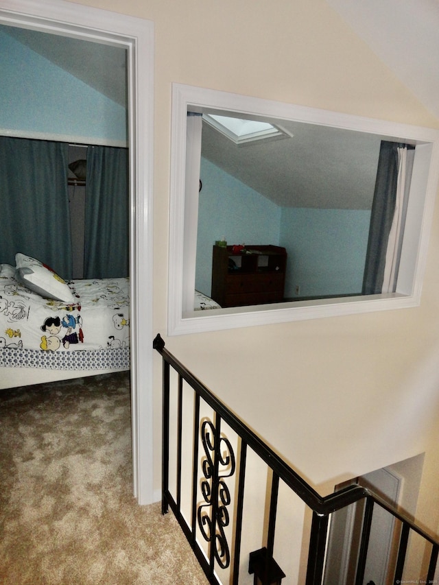 hall featuring lofted ceiling and carpet floors