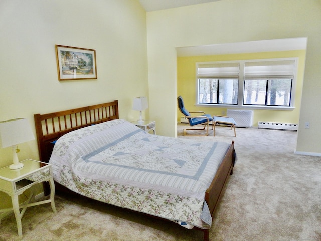 carpeted bedroom featuring a baseboard heating unit