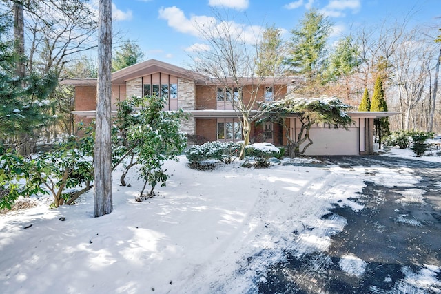 view of front of house with a garage and brick siding