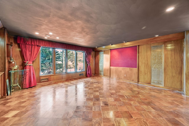 empty room featuring recessed lighting and wooden walls