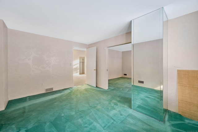 unfurnished bedroom featuring carpet floors and visible vents