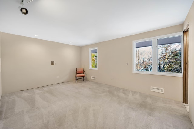 unfurnished room featuring light colored carpet