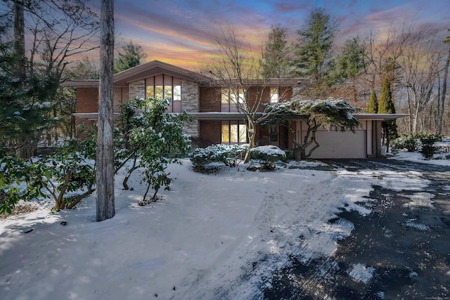 view of front of house with a garage and stone siding