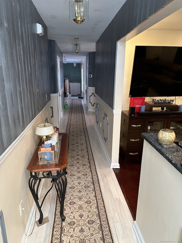 hallway with light hardwood / wood-style floors