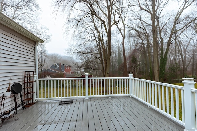 wooden deck featuring a lawn