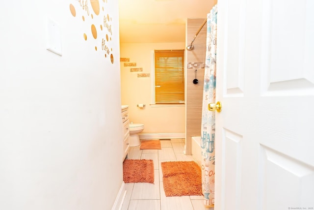 full bathroom with tile patterned flooring, vanity, shower / bath combo, and toilet