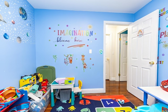 playroom with dark hardwood / wood-style floors