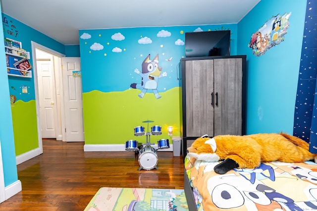 bedroom with dark hardwood / wood-style flooring