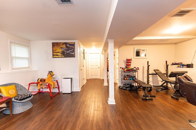 exercise room with wood-type flooring