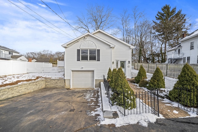 snow covered property featuring a garage