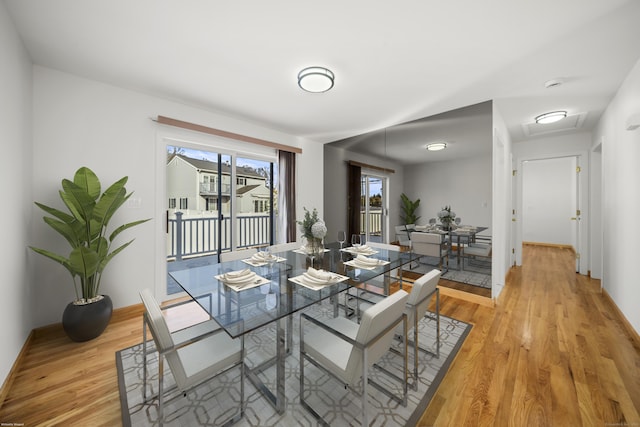 dining space with light hardwood / wood-style floors