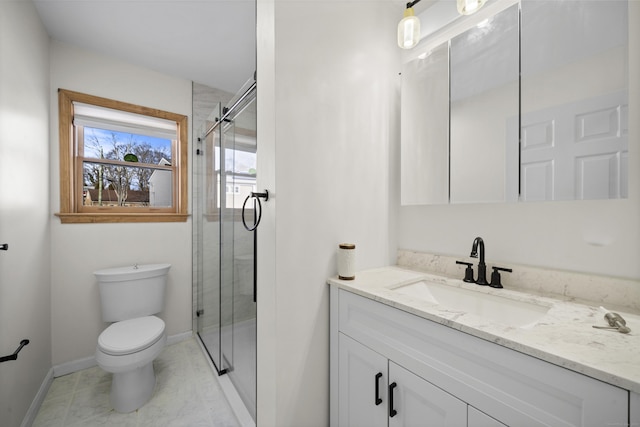 bathroom with vanity, a shower with shower door, and toilet