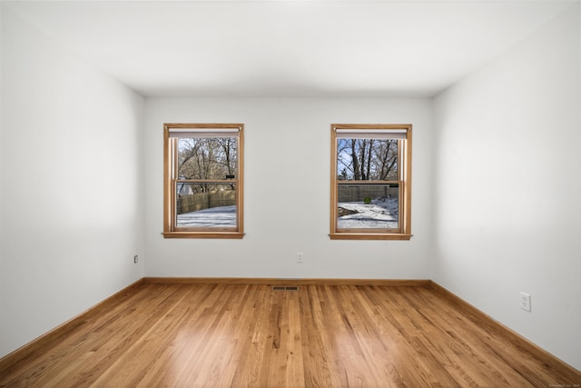 spare room featuring light hardwood / wood-style flooring