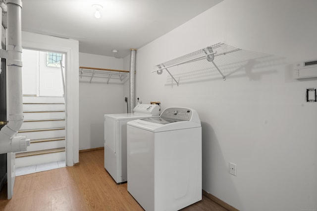 washroom featuring light wood-type flooring and washer and clothes dryer